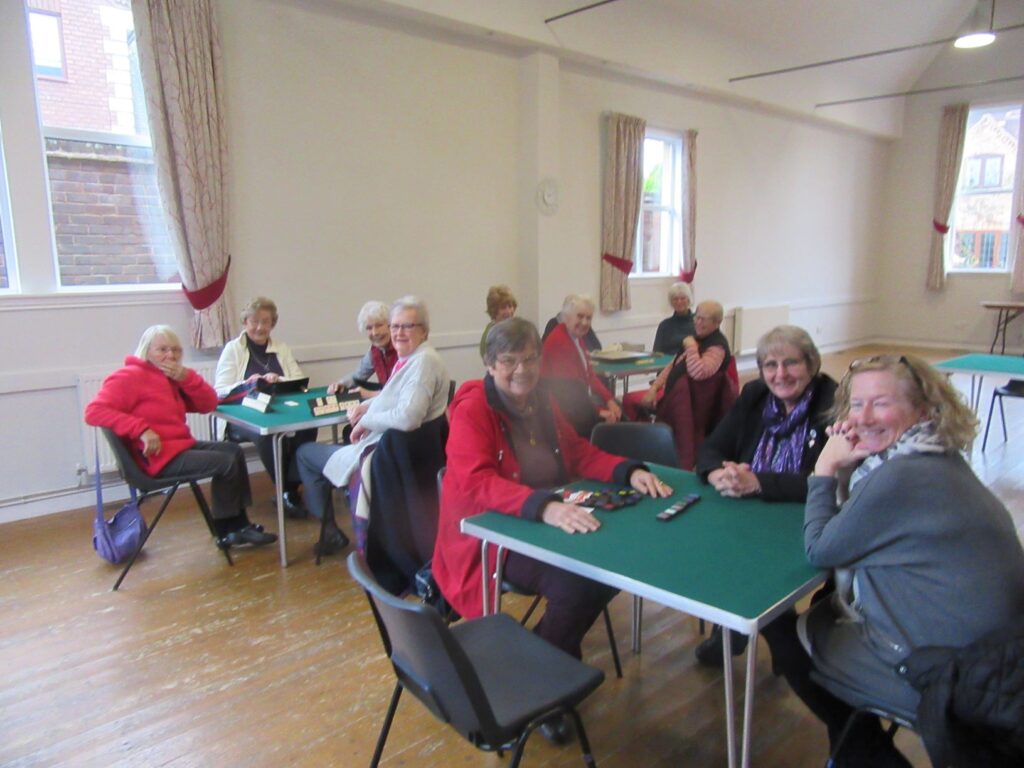 Smiling group members palying board games