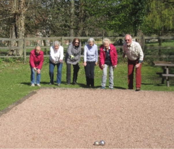 An image of a group of people playing pétanque