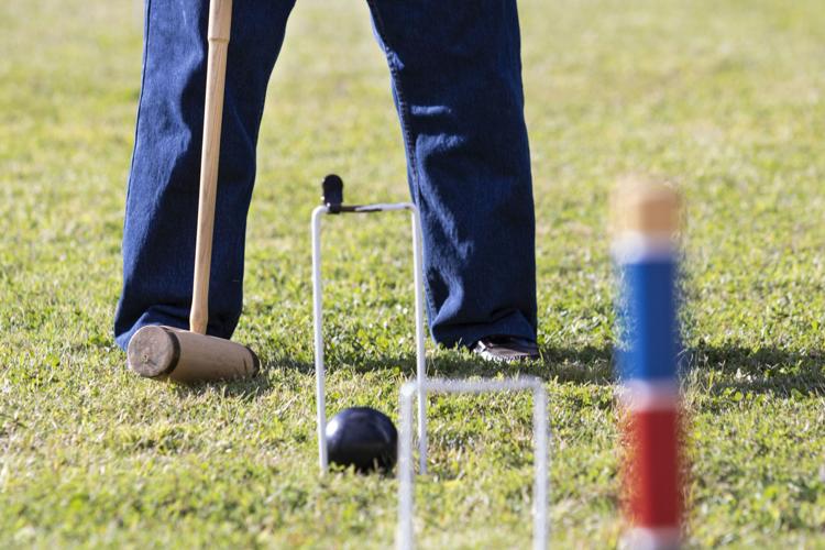 an image of a ball going through a croquet hoop