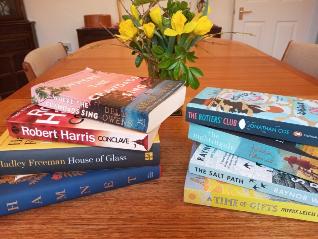 A pile of books on a table.