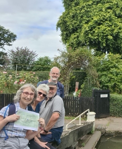 Wal;kers show a map alongside a lock on the canal.