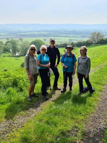 5 Walkovers members pose mid path